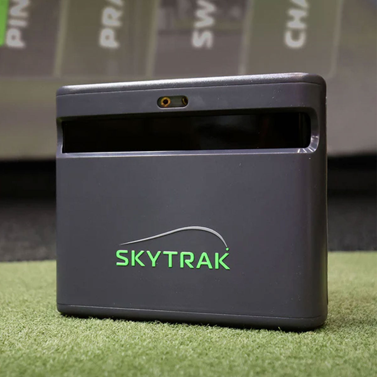 The SkyTrak ST MAX launch monitor and golf simulator on a golf hitting mat