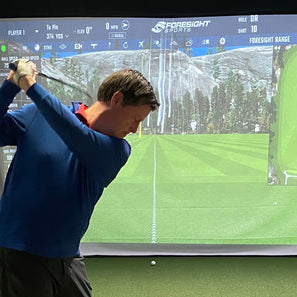 PlayBetter reviewer Marc swinging in an indoor golf simulator