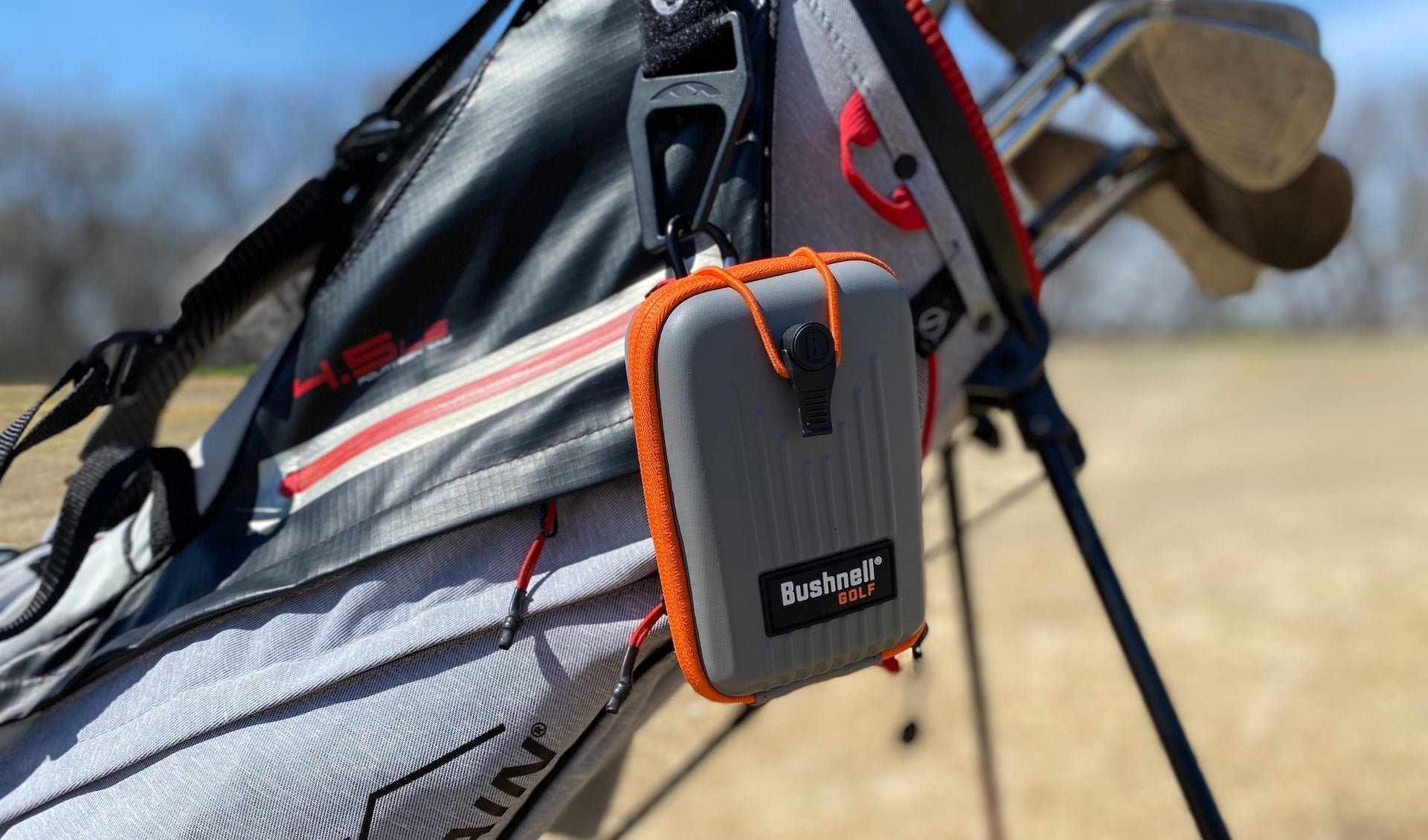 The Bushnell Pro X3 rangefinder case hanging from golf reviewer Marc's golf stand bag