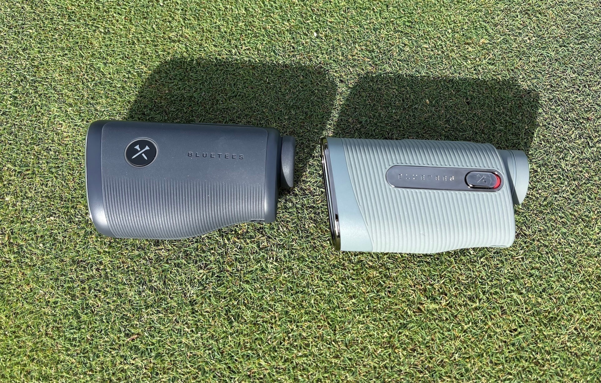The Blue Tees Captain Air and Captain Pro golf rangefinders on a golf hitting mat