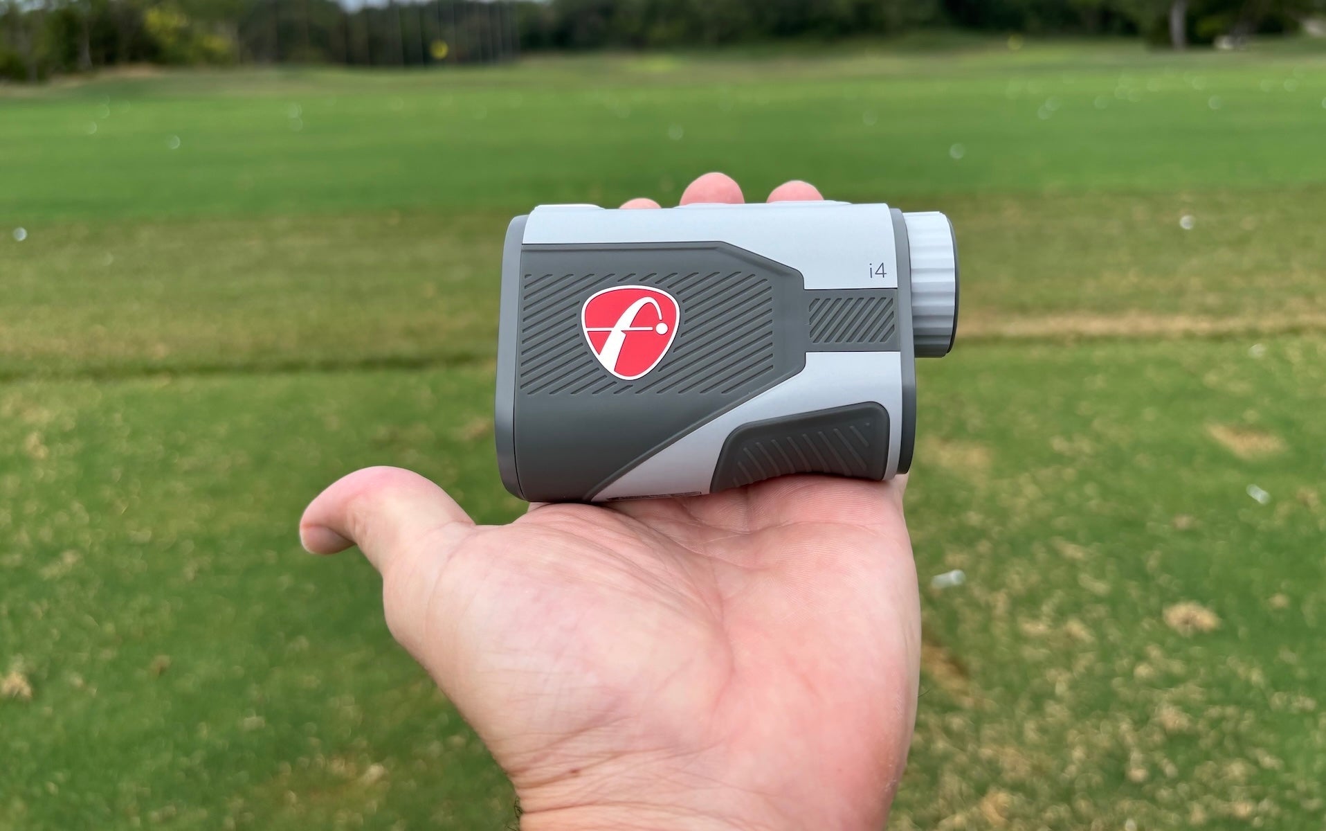The FlightScope i4 rangefinder in golf reviewer Marc's hand on the course