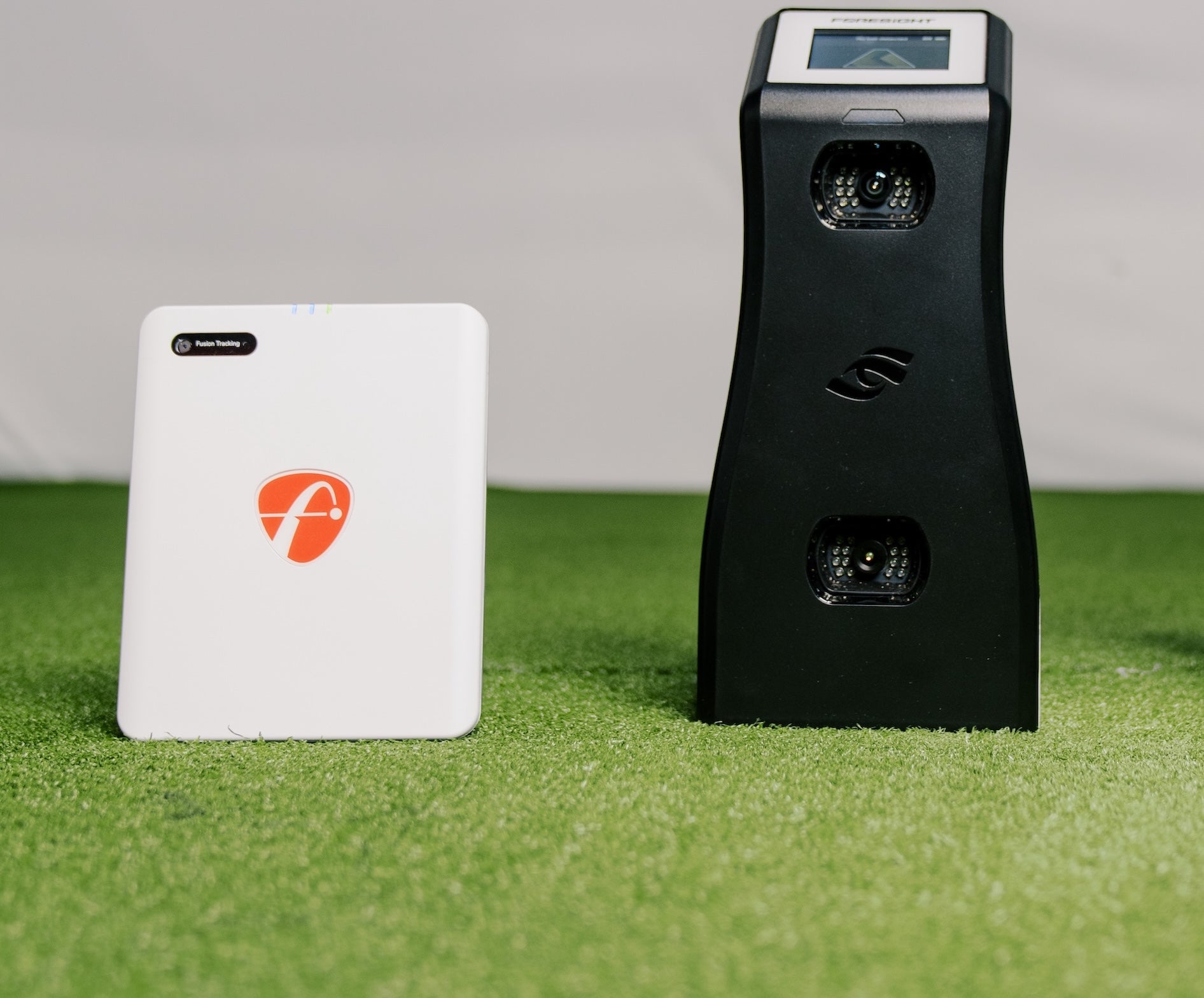 The FlightScope Mevo Gen2 launch monitor next to the Foresight GC2 in the PlayBetter golf simulator