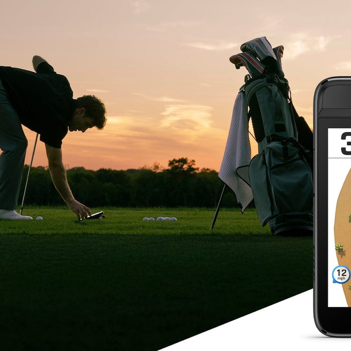 Golfer bending over to use the Garmin Approach G82 on a golf course with an image of the device also in the foreground showing yardage to the hole on the display