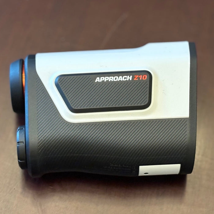 The Garmin Approach Z10 golf rangefinder on a woodgrain surface