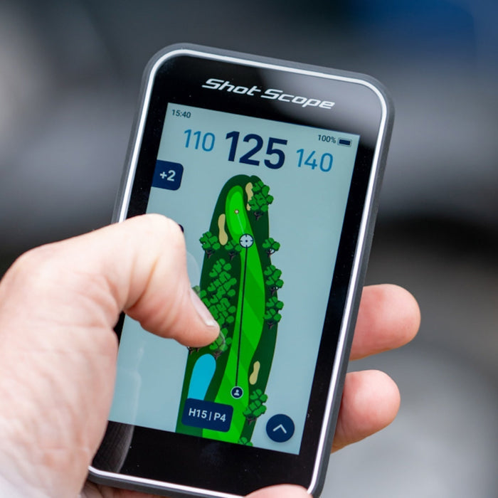 The Shot Scope H50 golf GPS handheld in a hand with golf hole graphic, features, and yardages on the display