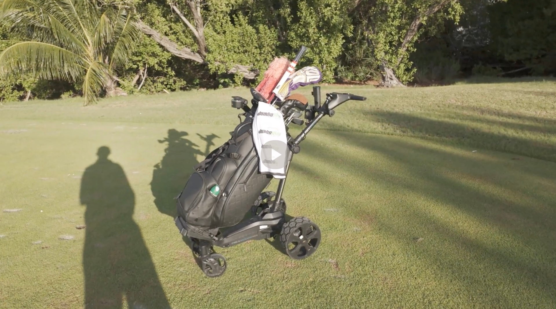 PlayBetter golf reviewer Daniel's shadow next to the MGI Ai Navigator Halo golf electric push cart on the course in Key West