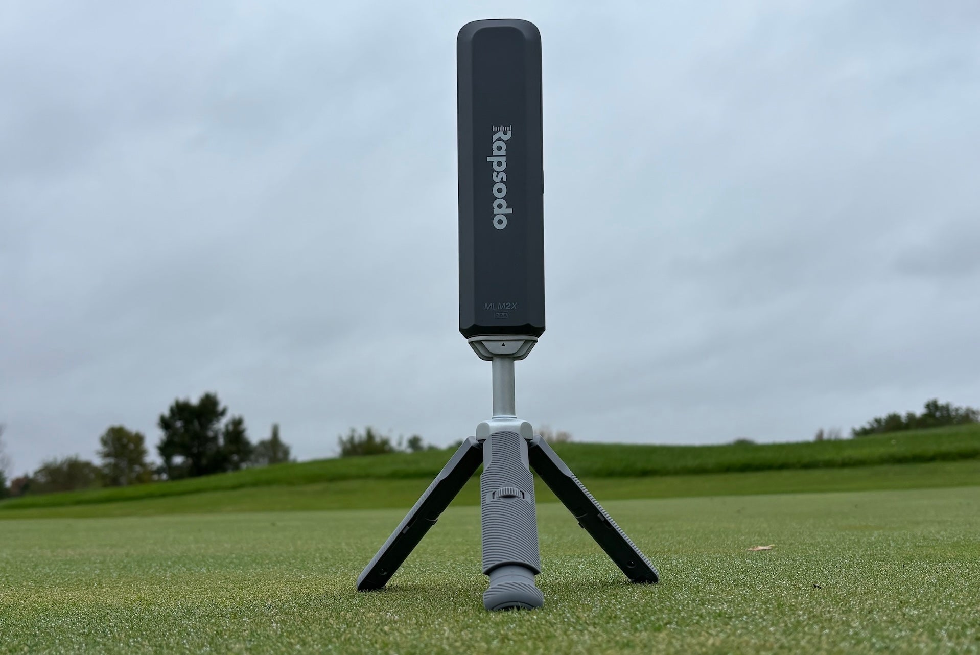 The Rapsodo MLM2XPRO launch monitor from behind on its tripod at the hitting range