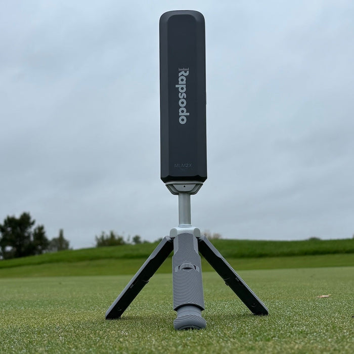 The Rapsodo MLM2XPRO launch monitor from behind on its tripod at the hitting range