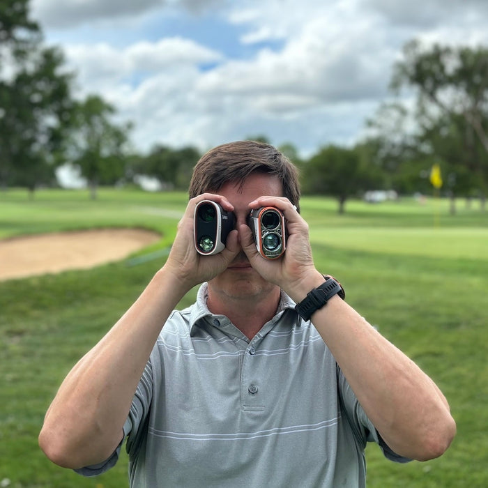 Golf reviewer Marc using two golf rangefinders on the golf course