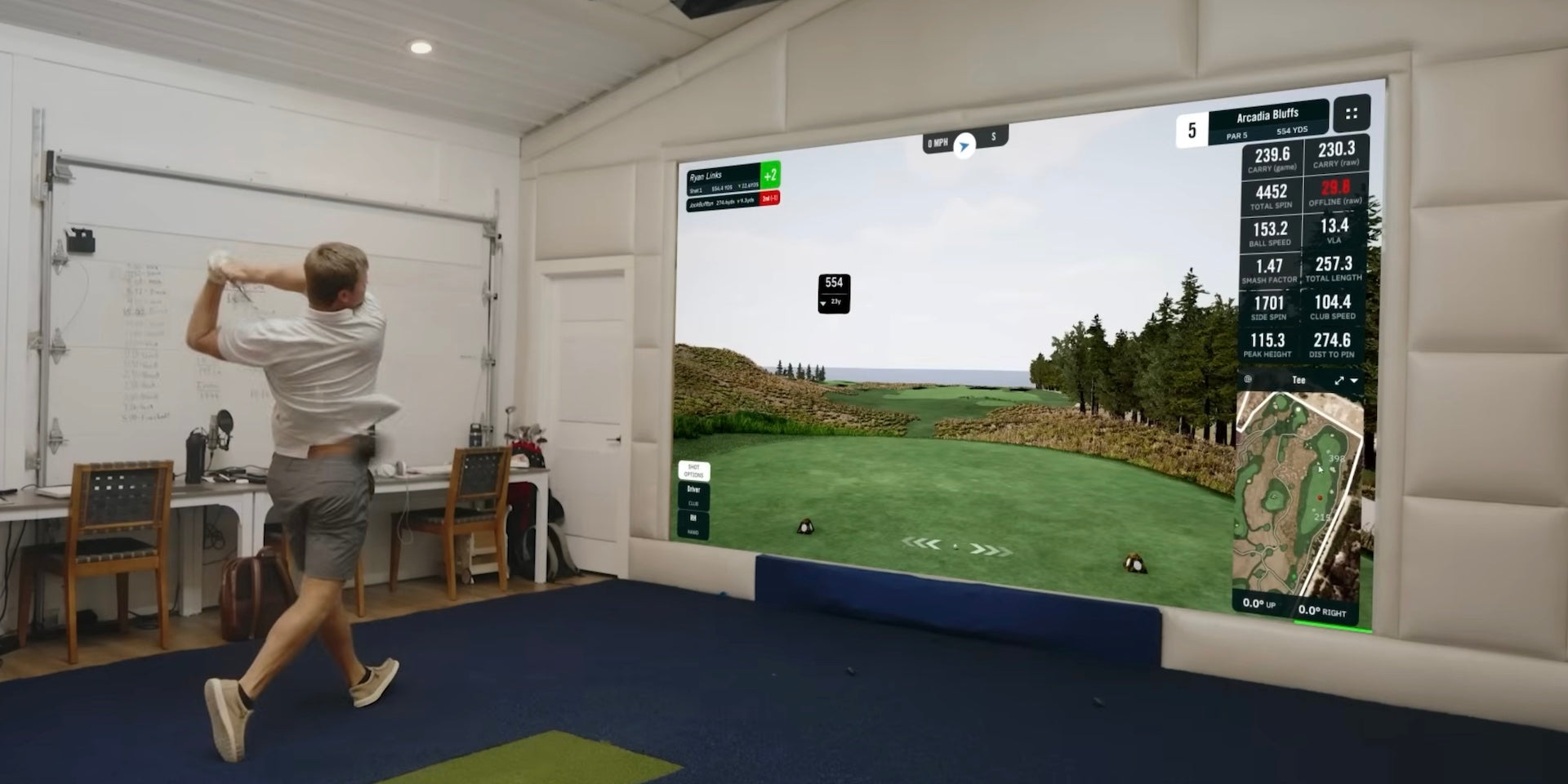 A golfer from GolfBusters post swing in a golf simulator using the FlightScope Mevo Gen2