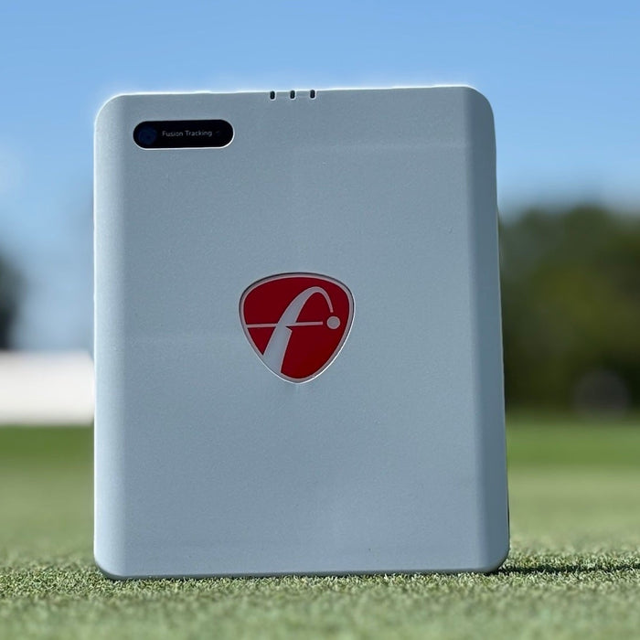 Front view of the FlightScope Mevo Gen2 golf launch monitor setting on a golf mat at the driving range