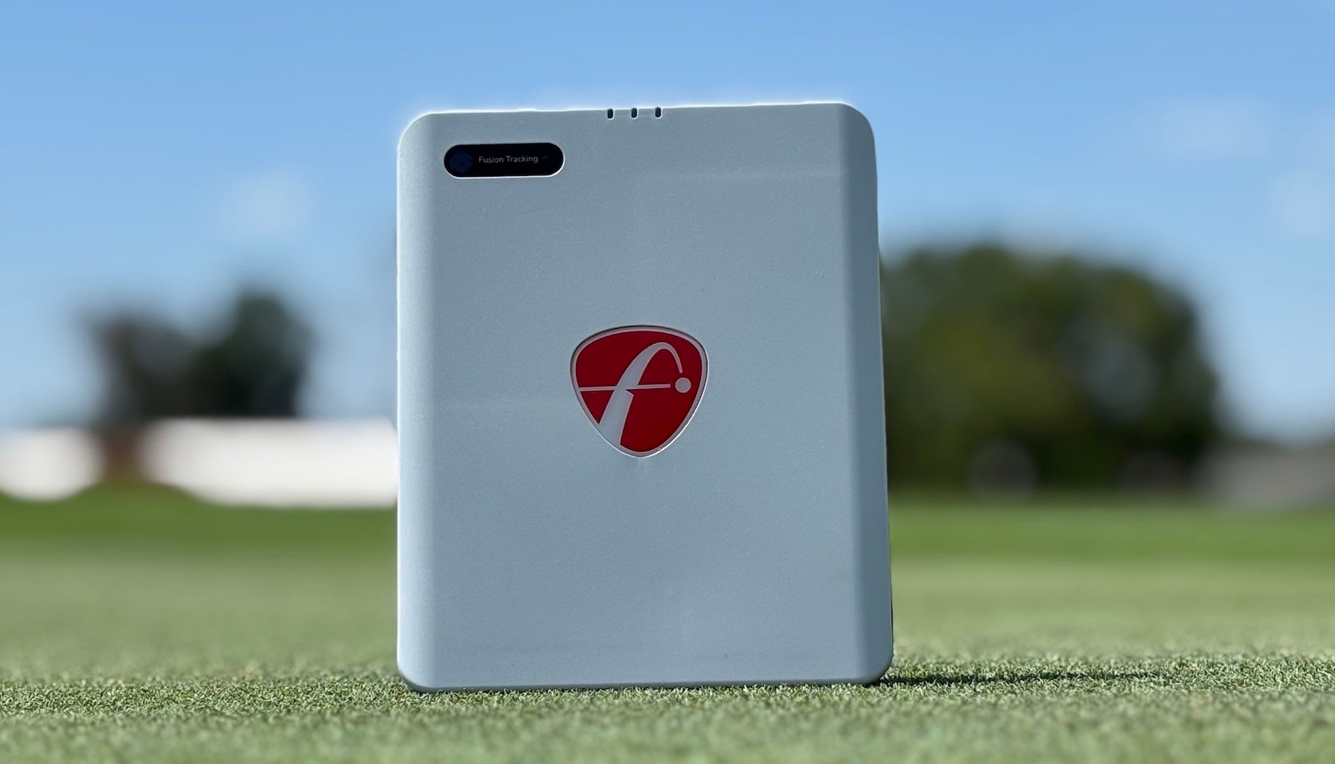 Front view of the FlightScope Mevo Gen2 golf launch monitor setting on a golf mat at the driving range