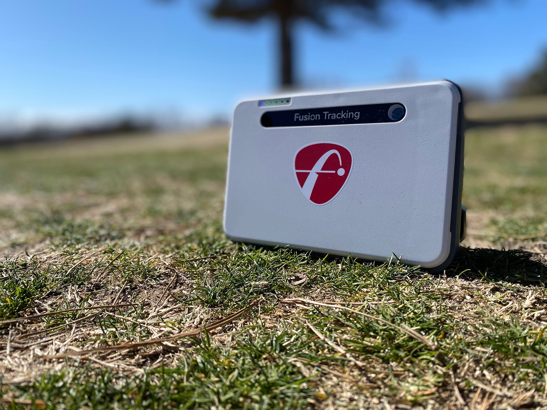 The FlightScope Mevo+ Limited Edition setting on the grass at the golf course