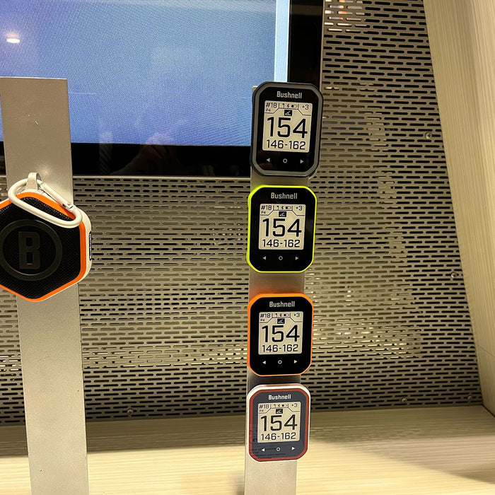The four Bushnell Phantom 3 GPS handhelds and Wingman Mini speaker on display at the 2024 PGA Sho