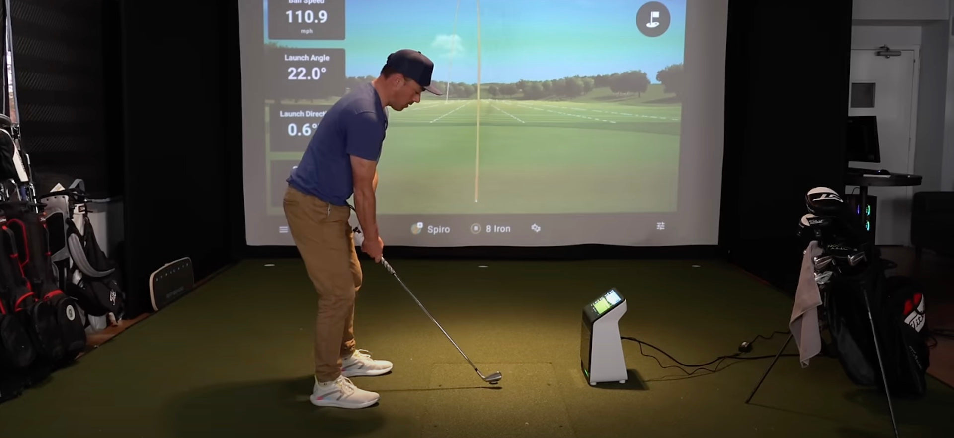 Frank from Golficity in a golf simulator with the Garmin Approach R50 golf launch monitor