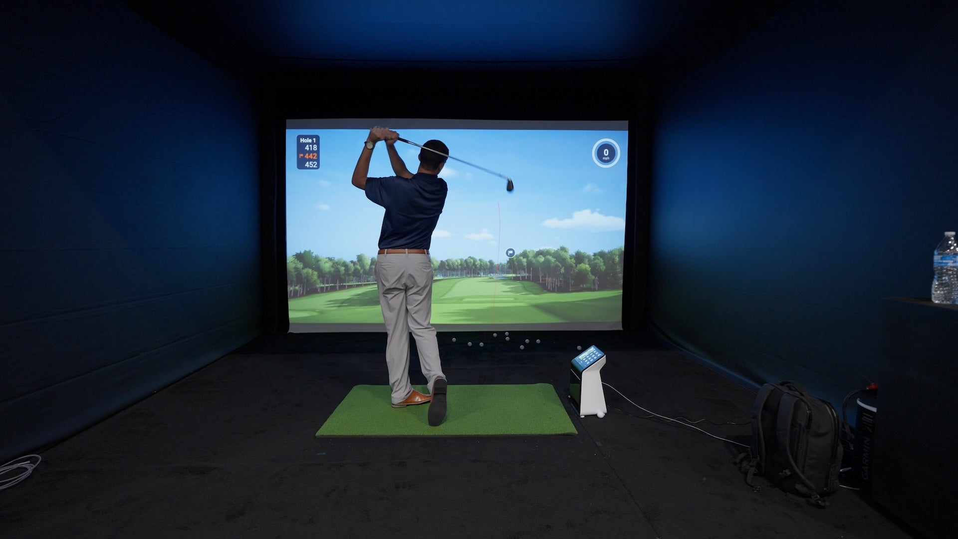 Daniel post swing in the Garmin Approach R50 golf simulator at the PGA Show