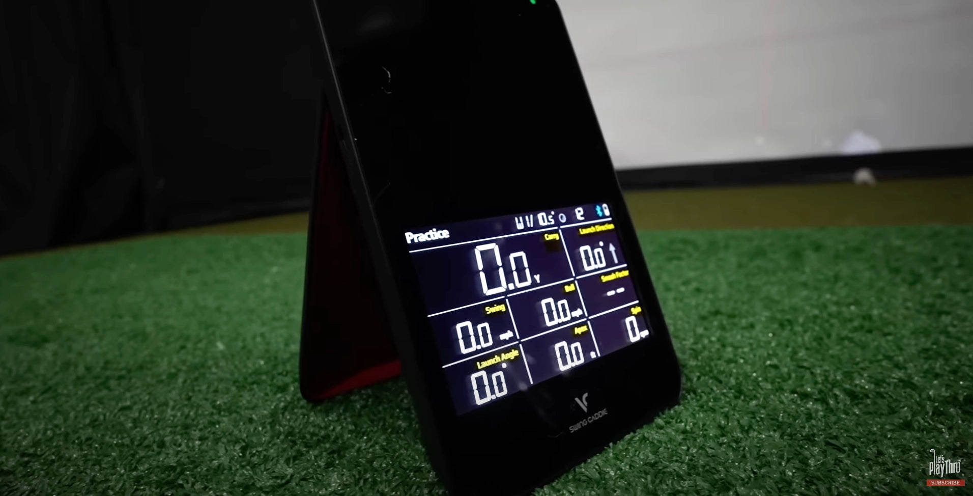 The Swing Caddie SC4 launch monitor set up in a golf simulator