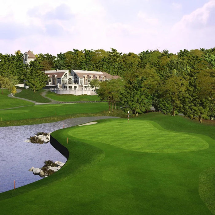 A Trackman Course Play golf course hole by a pond with a clubhouse in the background