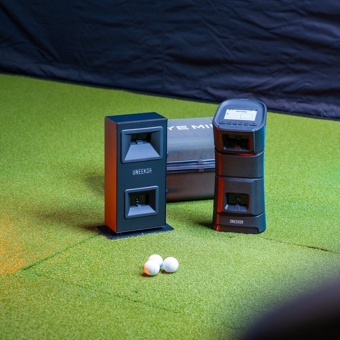 Uneekor Eye Min Lite and Eye Mini golf launch monitors next to each other in the PlayBetter golf simulator