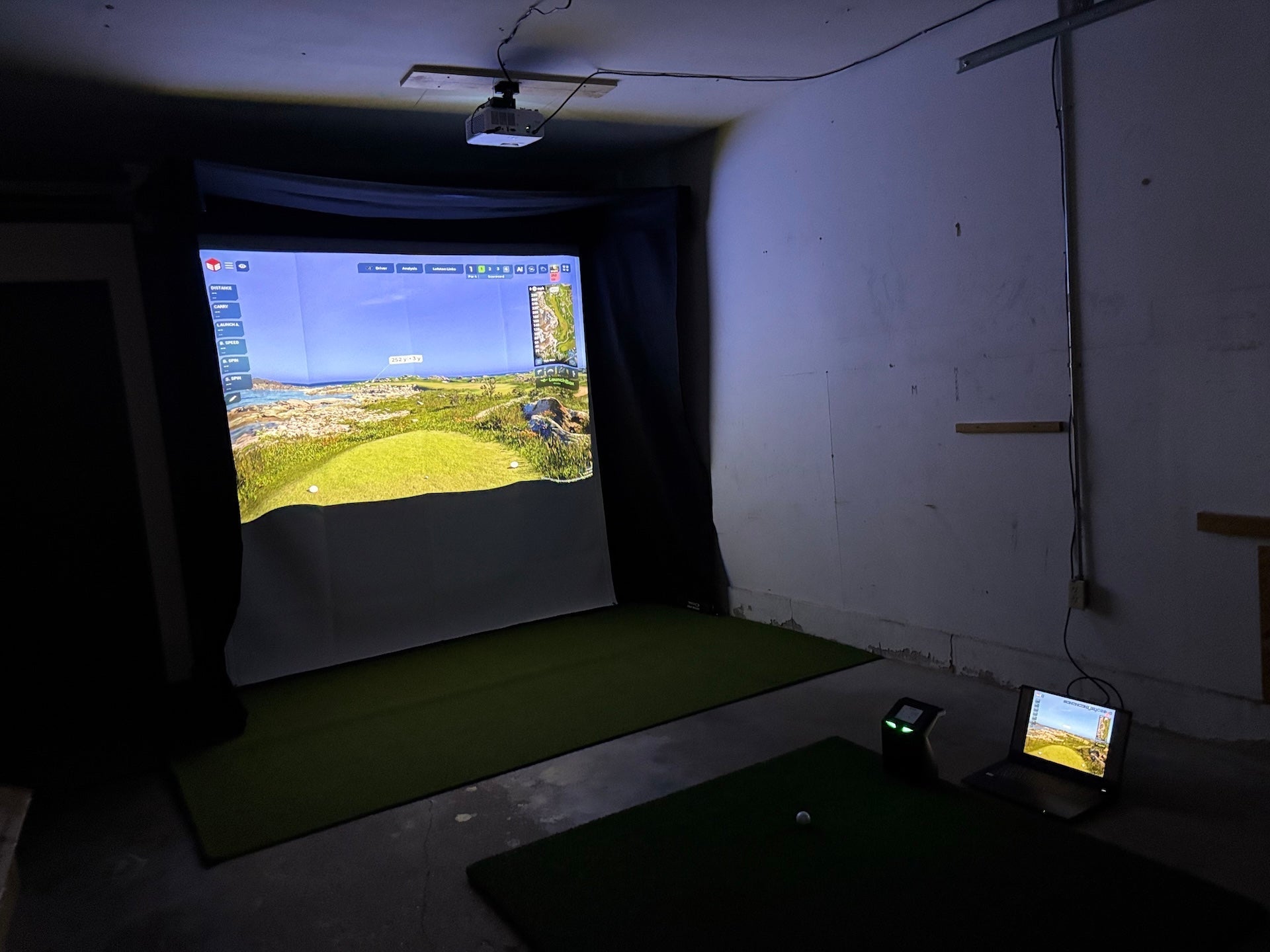 The SportScreen Vanish Lite hybrid-retractable golf enclosure in PlayBetter golf reviewer Marc's garage