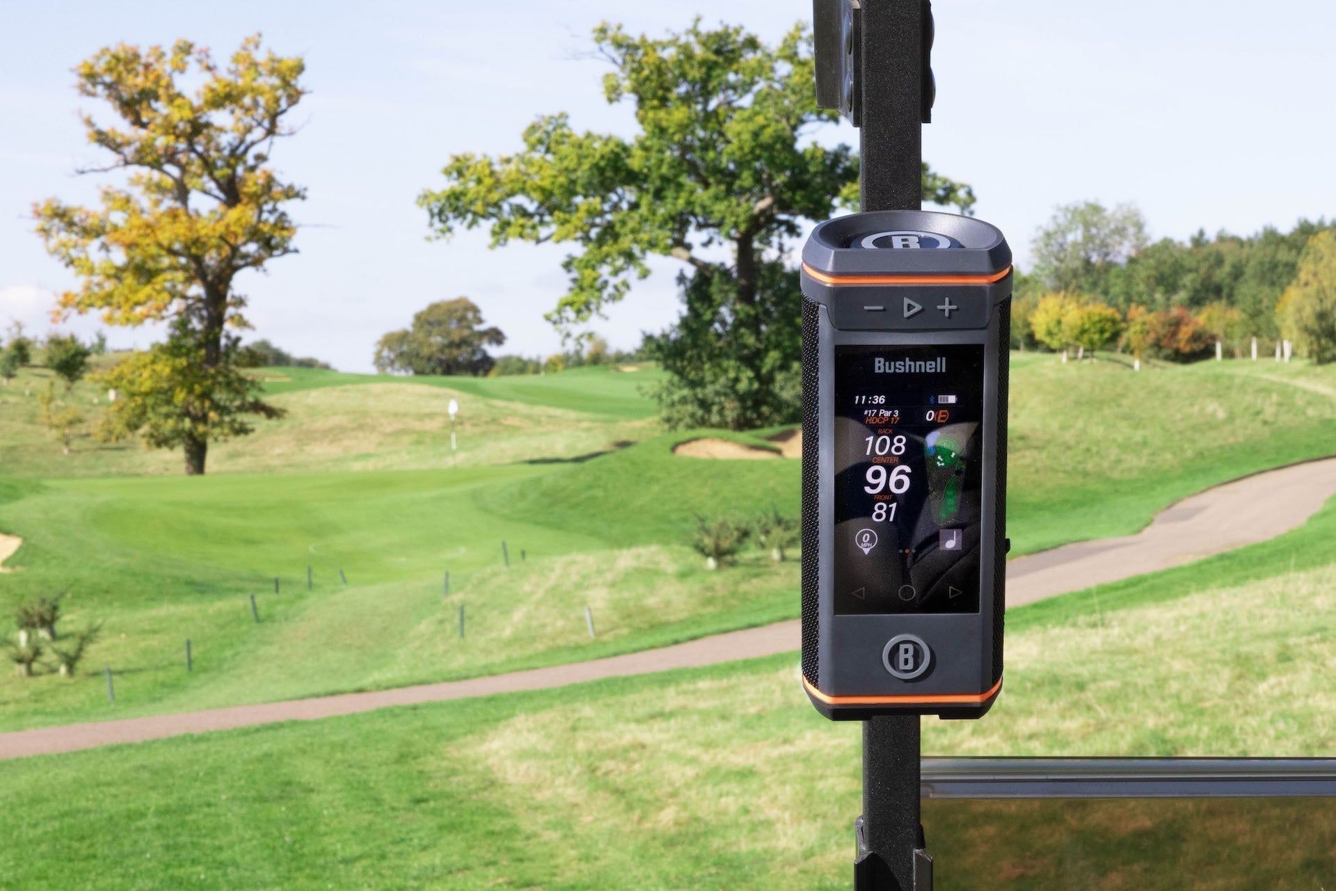 Front view of the Bushnell Wingman HD golf speaker on the cart bar at a golf course