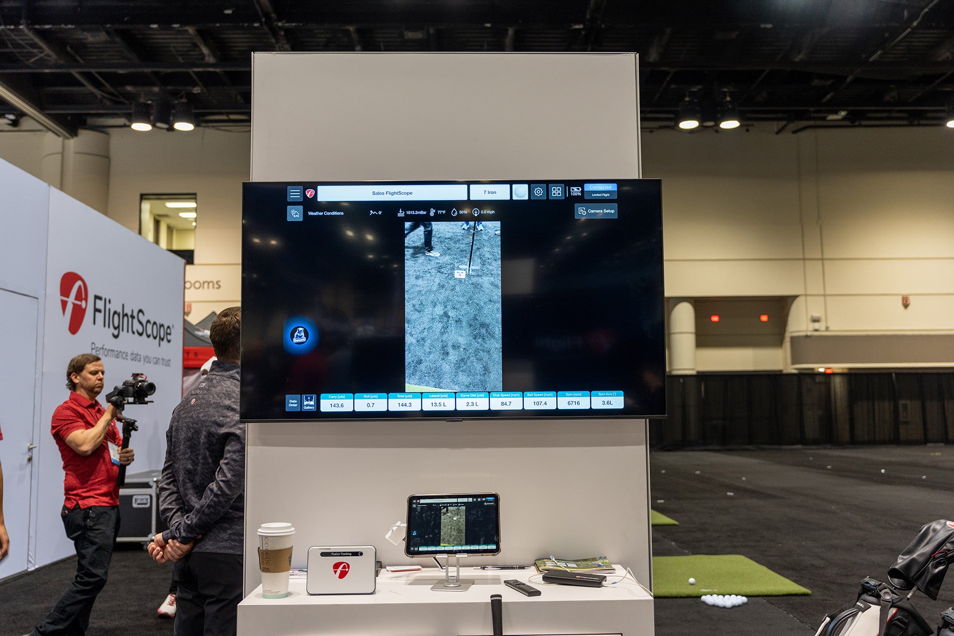 FlightScope Badger AI program on a flatscreen above a laptop at the 2024 PGA Show