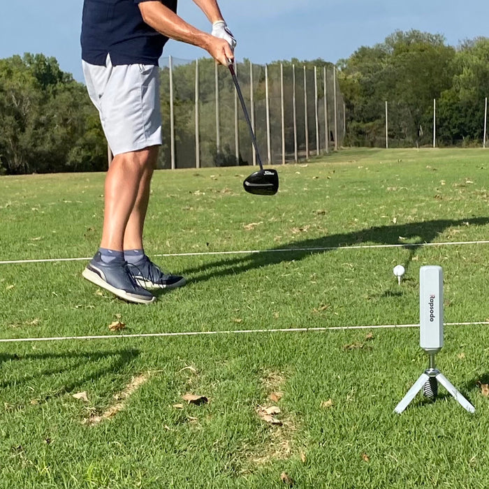 Marc's lower torso on the golf range in mid-swing in front of the Rapsodo MLM2PRO golf launch monitor