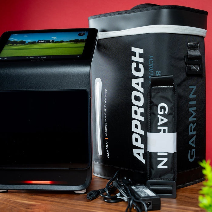 A Certified Pre-Owned Garmin Approach R50 Golf Launch Monitor with its carry case against a red background