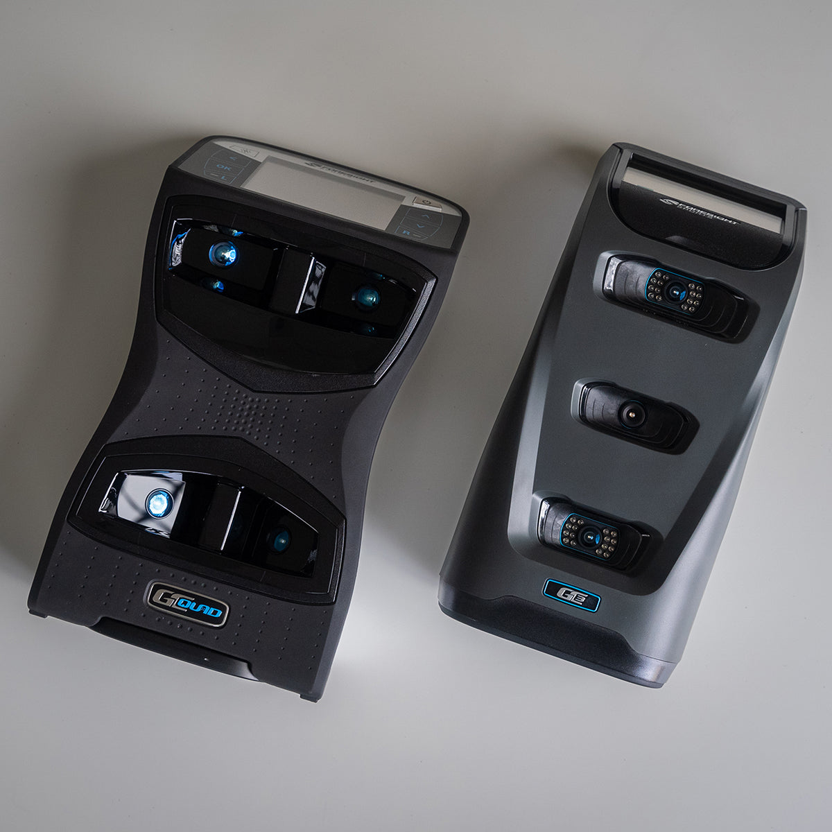 The Foresight GCQuad and GC3 launch monitor and golf simulators laying next to each other