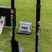 The rear view between two FlightScope poles of the Mevo+ Limited Edition and the X3 golf launch monitors on the golf range at the 2024 PGA Show