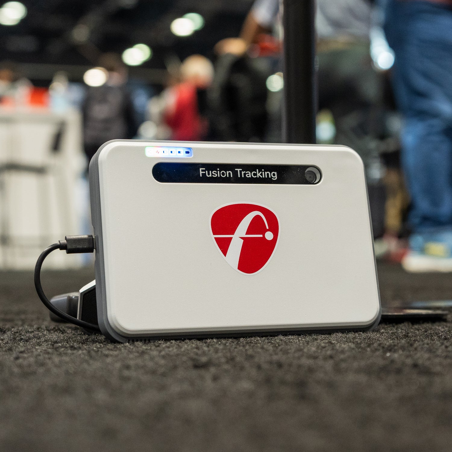 The FlightScope Mevo+ Limited Edition golf launch monitor on the floor at the 2024 PGA Show