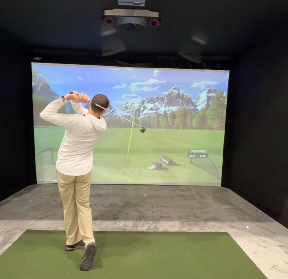 PlayBetter Expert Daniel in a ProTee VX golf simulator at the PGA Show