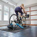 Woman using the Tacx Booster Indoor Trainer at home 