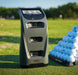 bushnell launch pro golf simulator & launch monitor sitting on a golf driving range in front of some golf balls
