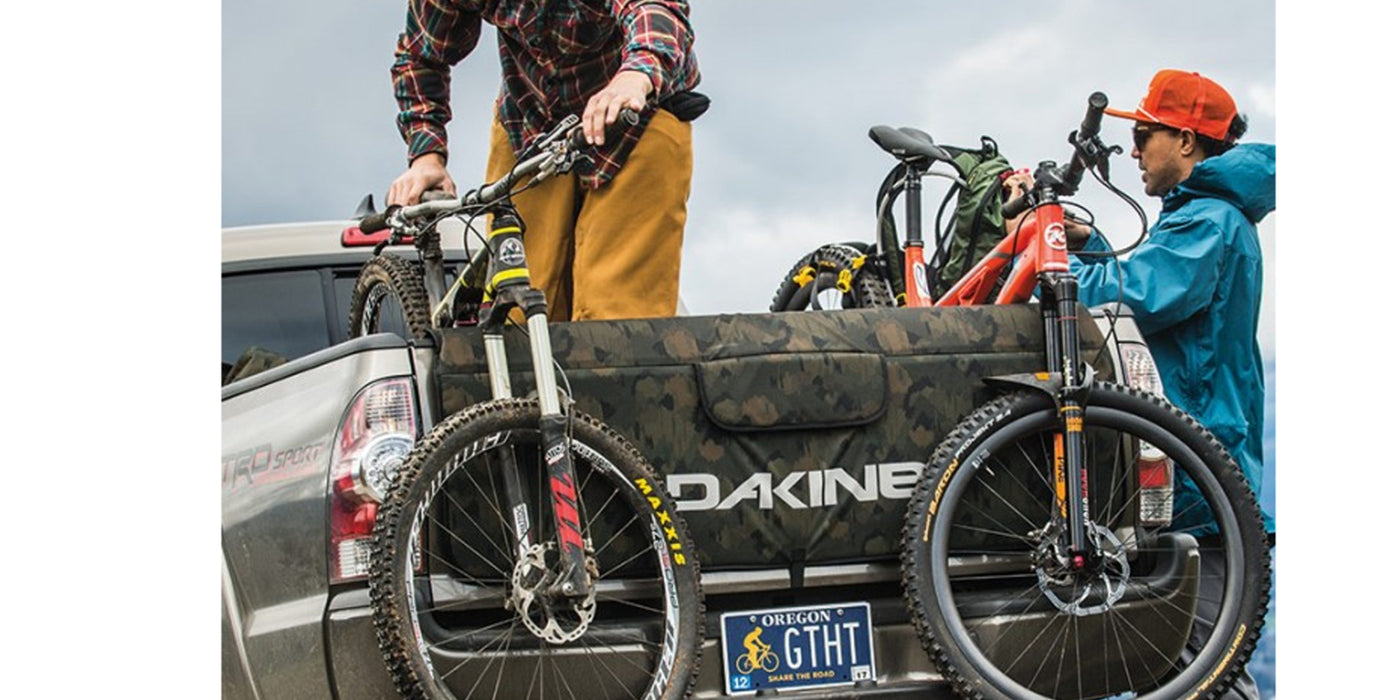 Bikers securely anchoring and transporting their bikes in the truck using the Dakine Pickup Pad